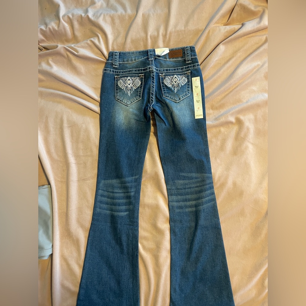 New With Tags Shyanne girls size 8 bootcut jeans.  Embroidered back pockets.